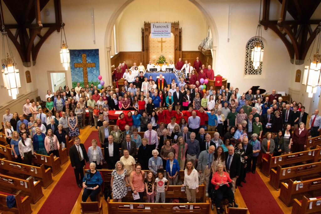 Full congregation of the Hancock church standing together in the chapel.